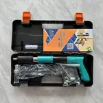 Mini powder nail gun, teal version, with cleaning brush and spare springs
