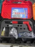 Powder nail gun for concrete and steel fixing, red body, kit accessories laid out